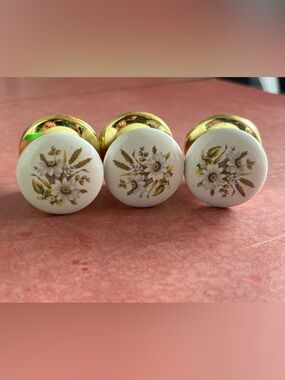 3x white glass knobs with floral motif